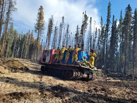 firemen standing on nodwell for transport